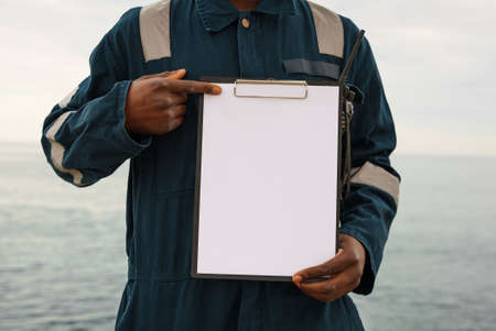 Crop seaman showing blank clipboardの写真素材