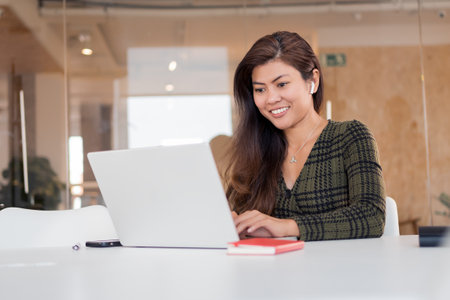 Modern smiling woman working on netbookの写真素材