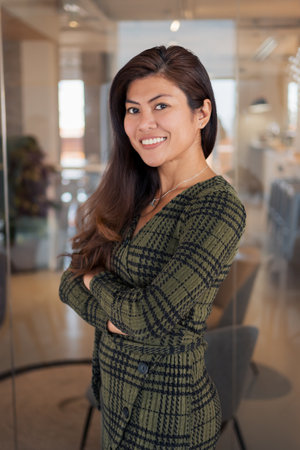 Smiling Asian worker standing in officeの写真素材
