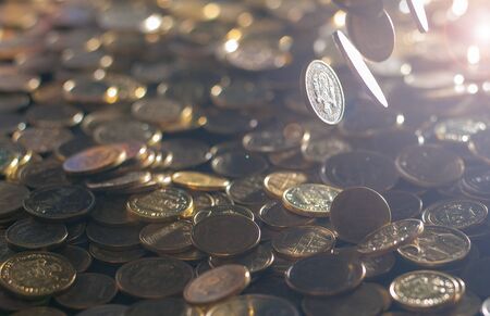 Banking and money trading. Metal coins stacked in different combinations on dark blue blurred background and lens flare. Serbian metal coins, copy space. Close up of metal money. Business conceptの写真素材