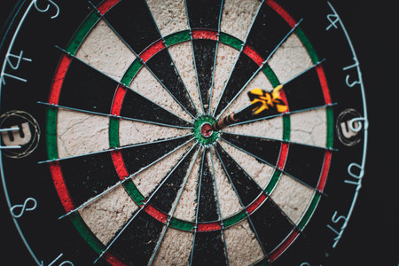 Dartboard with dart arrow in the center of the target.の写真素材