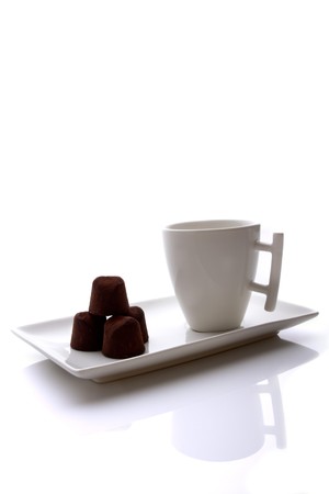 cup of coffee with cocoa candy on a white background.の写真素材