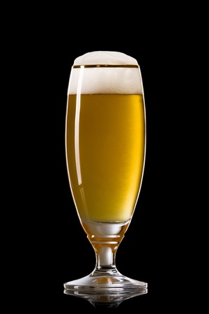 Beer into glass on a blackの写真素材