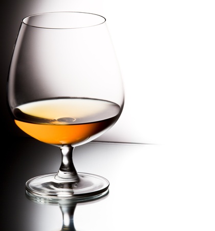 Glass of brandy over white backgroundの写真素材
