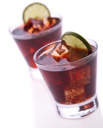 cocktail with lime and cola on white backgroundの写真素材