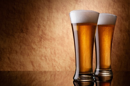 Beer into glass on a old stoneの写真素材