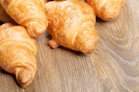 croissants on a wooden background with copyspaceの写真素材
