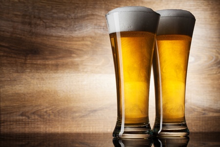 Two glass beer on wood background with copyspaceの写真素材