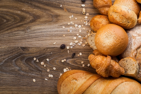 assortment of baked bread on wood table with copy space