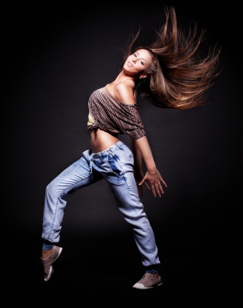 attractive young woman dancing, hair flyingの写真素材
