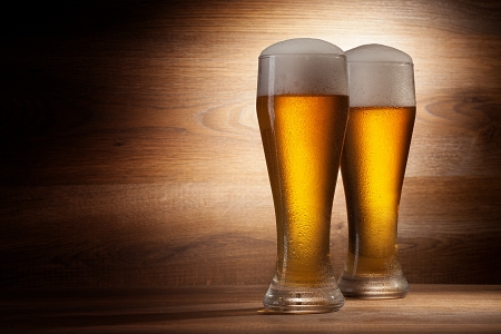 Beer into glass on a old stoneの写真素材