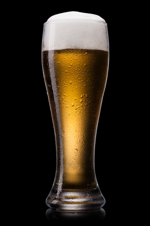 Beer into glass on a blackの写真素材