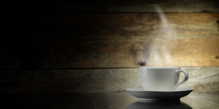 warm cup of coffee on wooden backgroundの写真素材
