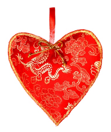 red textile heart on white background      の写真素材