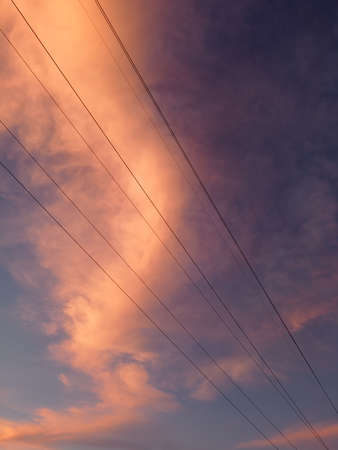 Electricity distribution station.Silhouette high voltage electric towers at sunset time....
