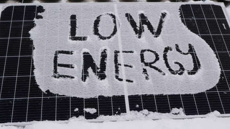 Low energy solar panel in the snow. Precipitation reduces the generation of electricity from solar cellsの写真素材
