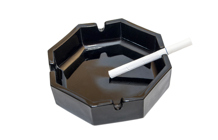 cigarette in the ashtray on a white backgroundの写真素材