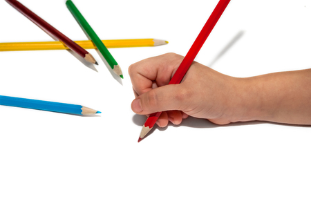 Children's hand with colored pencilsの写真素材