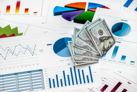 US dollars with charts and graphsの写真素材