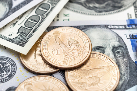 US coins on the dollar bills. Business concept.