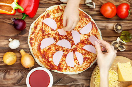Female and her daughter making pizza. Top view.の写真素材