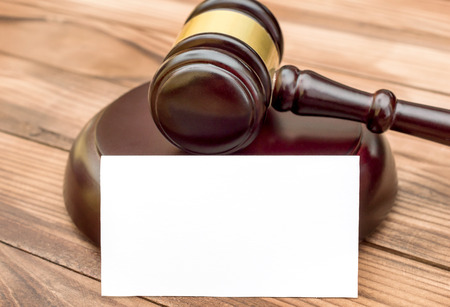 Blank business card with judge's gavel on the table.