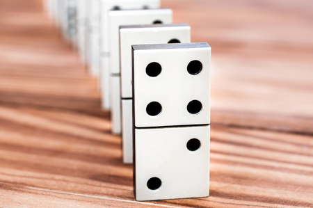 Row of dominoes on the wooden table.の写真素材
