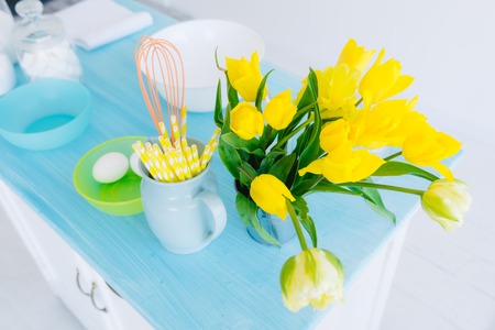 bouquet of tulips on a blue kitchen tableの写真素材