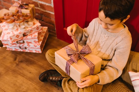 Little boy opening gift for christmas, birthday