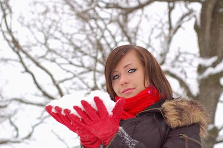 Woman hold snow in her hands