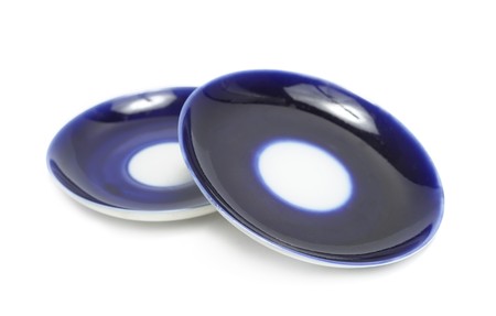 Two blue saucers isolated over whiteの写真素材