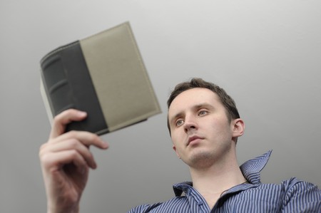 Man reading book over grey background