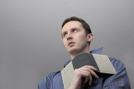 Man reading book over grey backgroundの写真素材