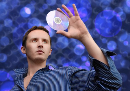 Man with compact disc in his handの写真素材
