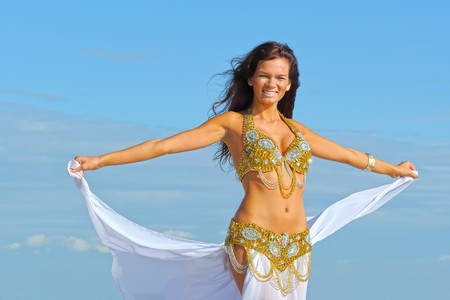 Beautiful woman in white exotic dressの写真素材