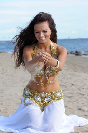 Beautiful woman play with sandの写真素材