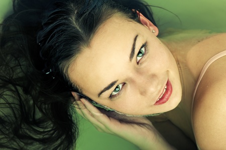 Woman portrait swimming in water close up