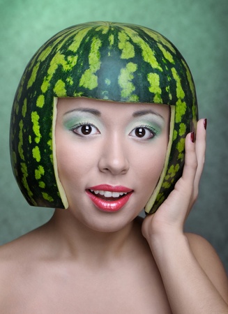 Woman with water-melon as helmetの写真素材