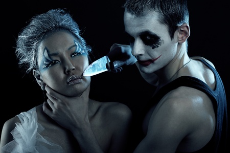 Spooky man with knife in darknessの写真素材