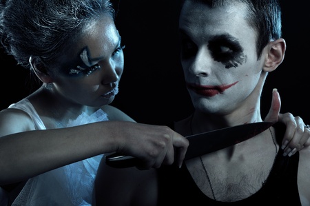 Spooky man and woman in darknessの写真素材