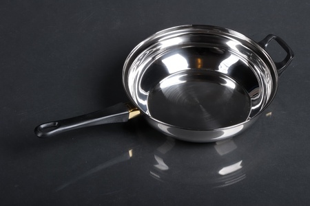 Metallic frying pan on black backgroundの写真素材
