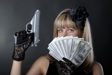 Gangster woman with pistol in blackの写真素材
