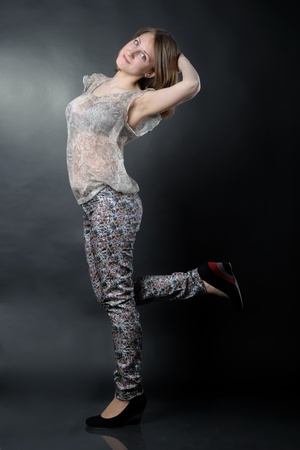 Slim girl in studio on black backgroundの写真素材