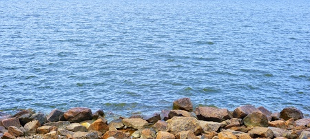 Water and stones among sea cliff の写真素材