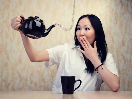 Girl and teapot at the table