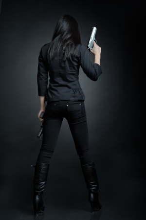 Asian woman with a pistolの写真素材