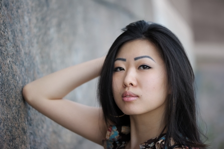 Portrait of asian woman near the wallの写真素材