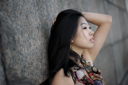 Portrait of asian woman near the wallの写真素材