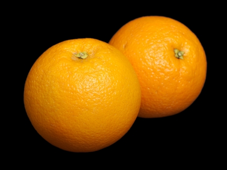 Orange fruit on black の写真素材