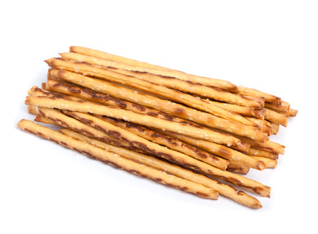 Closeup of a pile of delicious pretzel sticks isolated on white backgroundの写真素材